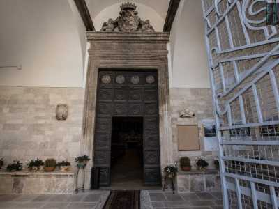 ...segnato da un portale ligneo del 1654 sormontato dal bassorilievo della Madonna del Suffragio